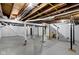 Unfinished basement with painted walls, concrete floor, exposed duct work and support beams at 5814 Beechwood Ave, Indianapolis, IN 46219