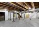 Unfinished basement with painted walls, concrete floor, exposed duct work and support beams at 5814 Beechwood Ave, Indianapolis, IN 46219