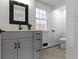 Modern bathroom featuring updated vanity with black hardware and fixtures and tile flooring at 5814 Beechwood Ave, Indianapolis, IN 46219