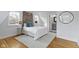Bright bedroom with exposed brick, hardwood floors, and ensuite bathroom at 5814 Beechwood Ave, Indianapolis, IN 46219