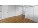 Bedroom with hardwood floors, white walls, and closet at 5814 Beechwood Ave, Indianapolis, IN 46219