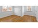 Bedroom features hardwood floors, white walls, and sliding closet doors at 5814 Beechwood Ave, Indianapolis, IN 46219