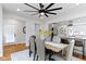 Open dining room featuring modern fixtures, natural light, and an open layout to the kitchen at 5814 Beechwood Ave, Indianapolis, IN 46219