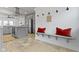 Mudroom with a bench, hooks, and gray cabinetry near the kitchen, offering convenience and storage at 5814 Beechwood Ave, Indianapolis, IN 46219