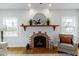 A cozy brick fireplace with a wooden mantel and decorative accents, creating a warm and inviting focal point at 5814 Beechwood Ave, Indianapolis, IN 46219