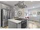 Modern kitchen with stainless steel appliances, quartz countertops, and gray cabinetry at 5814 Beechwood Ave, Indianapolis, IN 46219