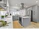 Bright and airy kitchen featuring gray cabinetry, stainless steel appliances, and a kitchen island at 5814 Beechwood Ave, Indianapolis, IN 46219