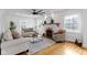 Inviting living room with fireplace, ceiling fan, neutral furniture, and hardwood floors creating a cozy space at 5814 Beechwood Ave, Indianapolis, IN 46219