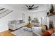 Living room with a ceiling fan, fireplace, hardwood floors, and neutral furniture for relaxation and entertainment at 5814 Beechwood Ave, Indianapolis, IN 46219