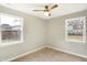 Bedroom with neutral walls, carpet, and natural light from two windows at 6104 Gifford St, Indianapolis, IN 46228