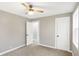 Neutral bedroom featuring a ceiling fan, two doors, and a window for natural light at 6104 Gifford St, Indianapolis, IN 46228
