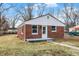 Well-maintained exterior with brick siding, a concrete front porch, and a lawn at 6104 Gifford St, Indianapolis, IN 46228