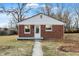 Charming brick home featuring a crisp white trim, a well-maintained walkway, and a cozy front yard at 6104 Gifford St, Indianapolis, IN 46228
