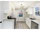 Modern kitchen featuring white cabinetry, stainless steel appliances, and elegant countertops at 6104 Gifford St, Indianapolis, IN 46228