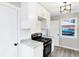 Stylish kitchen boasts white cabinets, stainless steel range, and complementing countertops at 6104 Gifford St, Indianapolis, IN 46228
