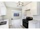 Open kitchen design featuring stainless steel appliances, bright light and access to the living room at 6104 Gifford St, Indianapolis, IN 46228