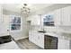 Bright kitchen features white cabinets, stainless steel appliances, and a modern light fixture at 6104 Gifford St, Indianapolis, IN 46228