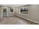 Bright living room featuring hardwood floors, large windows, and a neutral color palette throughout at 6104 Gifford St, Indianapolis, IN 46228