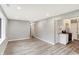 Stylish living area with hardwood floors, neutral paint, and seamless transition to the modern kitchen at 6104 Gifford St, Indianapolis, IN 46228