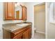 Bathroom with a wood vanity, granite countertop, and a toilet room at 647 Mulford Ct, Indianapolis, IN 46234