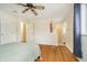 Sunlit bedroom featuring hardwood floors, a ceiling fan and ensuite bathroom at 647 Mulford Ct, Indianapolis, IN 46234