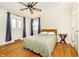 A sunny bedroom with hardwood floors, a ceiling fan and two windows at 647 Mulford Ct, Indianapolis, IN 46234