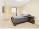 Cozy bedroom featuring a plush bed, natural light, and stylish side tables at 647 Mulford Ct, Indianapolis, IN 46234