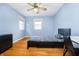 Bedroom featuring blue walls, hardwood floors, and a window for natural light at 647 Mulford Ct, Indianapolis, IN 46234