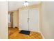 Entryway with hardwood floors, neutral walls, and a coat closet at 647 Mulford Ct, Indianapolis, IN 46234