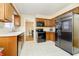 Kitchen featuring wooden cabinets and stainless steel refrigerator at 647 Mulford Ct, Indianapolis, IN 46234