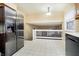 Kitchen area showcasing stainless steel appliances and white railing to upper level at 647 Mulford Ct, Indianapolis, IN 46234