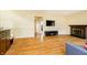 Spacious living room with a fireplace, a mounted TV, and wood flooring at 647 Mulford Ct, Indianapolis, IN 46234