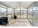 The sunroom is bright, with large windows and a ceiling fan for year-round enjoyment at 647 Mulford Ct, Indianapolis, IN 46234