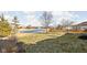 Tranquil backyard with pond views, mature trees, and well-maintained lawn at 649 Hummingbird Dr, Brownsburg, IN 46112