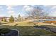 Scenic backyard with a pond view, lush lawn, trees, and landscaping at 649 Hummingbird Dr, Brownsburg, IN 46112