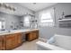 Bathroom with double vanity, large tub, and decorative accents and ample natural light at 649 Hummingbird Dr, Brownsburg, IN 46112