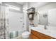 Bright bathroom features a shower-tub combo, storage for towels, and wood vanity with a white countertop at 649 Hummingbird Dr, Brownsburg, IN 46112