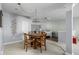 Basement dining area with a wooden table, seating for four, and a view to a kitchenette at 649 Hummingbird Dr, Brownsburg, IN 46112