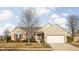 Charming brick home featuring a two-car garage and a welcoming front entrance with red shutters at 649 Hummingbird Dr, Brownsburg, IN 46112
