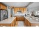 Spacious kitchen featuring wooden cabinets, stainless steel appliances, and a large island at 649 Hummingbird Dr, Brownsburg, IN 46112