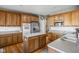 Traditional kitchen with wood cabinets, stainless steel appliances, and island with stone countertops at 649 Hummingbird Dr, Brownsburg, IN 46112