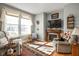 Cozy living room featuring a fireplace, large windows, and comfortable seating at 649 Hummingbird Dr, Brownsburg, IN 46112