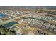 Aerial view of a neighborhood showcasing pond, streets, and homes in a developing community surrounded by trees and fields at 6890 Enclave Dr, McCordsville, IN 46055