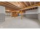 Unfinished basement with concrete walls and floor offers lots of open space with exposed wood joists and utilities at 6890 Enclave Dr, McCordsville, IN 46055