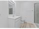 Bathroom showcasing a single vanity sink, toilet, towel rack, and tile-walled shower with glass door at 6890 Enclave Dr, McCordsville, IN 46055