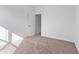 Clean bedroom with neutral carpet, white walls and trim, a window with natural light, and a closet at 6890 Enclave Dr, McCordsville, IN 46055