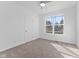 Bright bedroom features a neutral color palette, carpeted floors, and a large window with natural light at 6890 Enclave Dr, McCordsville, IN 46055