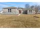 An inviting single-story house showcasing a stone and brick facade, set against a spacious front lawn at 6890 Enclave Dr, McCordsville, IN 46055