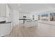 Spacious kitchen with white cabinets, black countertops, stainless appliances, and a large center island at 6890 Enclave Dr, McCordsville, IN 46055