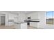 Bright kitchen features a large island, granite countertops, stainless steel appliances, and views of the lake at 6890 Enclave Dr, McCordsville, IN 46055